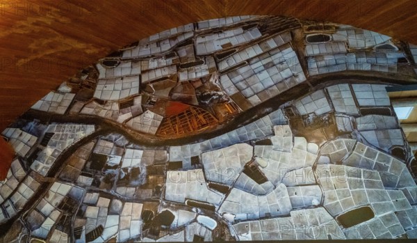 Anana salt pans filling a valley, creating a textured landscape of geometric shapes and water pools, illustrating traditional salt production in the basque country