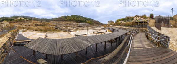 Anana salt flats showing ancient salt evaporation ponds in the salt valley, featuring a network of wooden walkways providing access across the historical basque country landscape