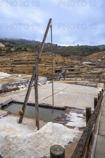 Ancient terraced salt pans extracting salt from brine, showcasing a traditional and historical method of salt production in the salt valley of anana, basque country