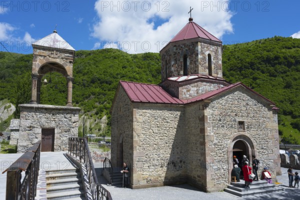 Stone church with bell tower against green landscape and blue sky, Kvemo Mleta Lomis dome church, Kvemo Mleta, Mtskheta-Mtianeti region, Georgian Military Route, High Caucasus, Georgia