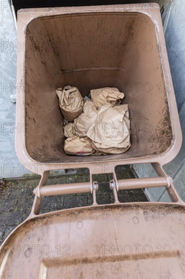 Full brown organic waste bin for food disposal. Germany