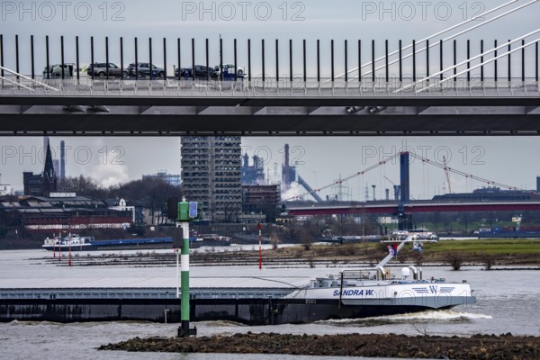 Shipping traffic on the Rhine near Duisburg-Homberg, new A40 motorway, Neuenkamp Rhine bridge, first construction phase, Friedrich-Ebert bridge between Homberg and Ruhrort in the back, industrial setting of the ThyssenKrupp steel plant, North Rhine-Westphalia, Germany