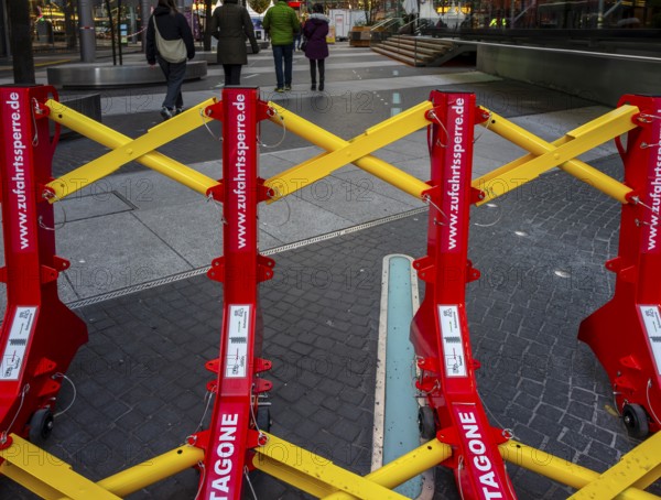 Massive metal access barriers in red and yellow at Center Potsdamer Platz, Berlin, Germany