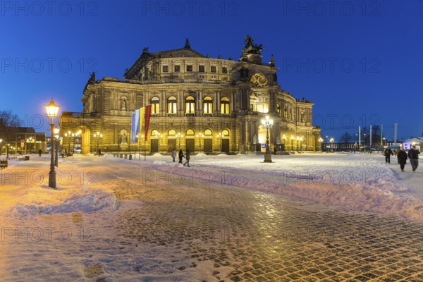 Illuminated Semper Opera House and Theatre Square with snow at dusk, Old Town of Dresden, Saxony, Germany