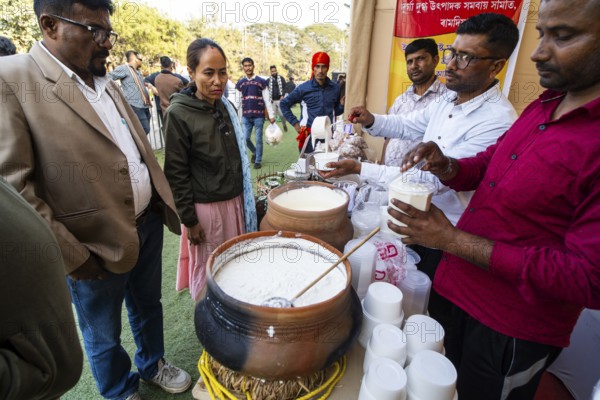Vendor selling curd and cream dairy product at a stall in Bhogali Mela, ahead of the 'Magh Bihu' festival, in Guwahati, Assam, India on January 12, 2026. Magh Bihu, also called Bhogali Bihu, is Assam's harvest festival marking the end of the agricultural season and celebrated with feasts, community bonfires, and traditional food