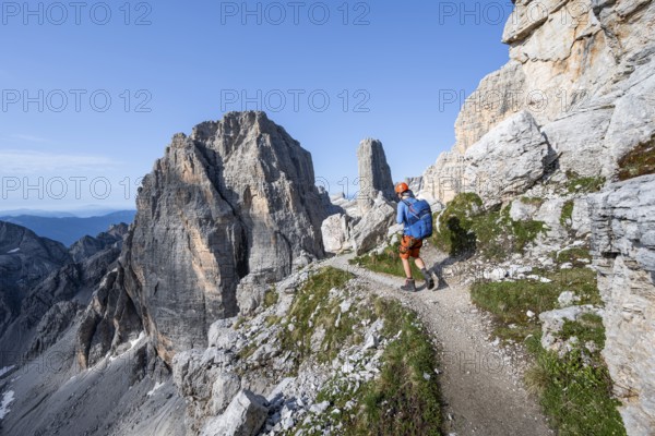 Mountaineers on a hiking trail, Via Ferrata Bocciere Centrale via ferrata, spectacular mountain landscape with steep rocky peaks, Brenta-Adamello Nature Park, Trentino, Italy