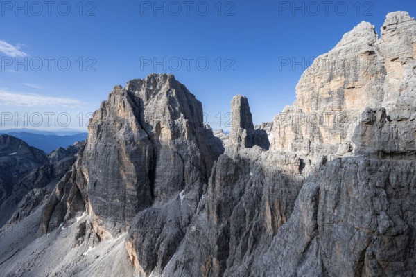 Trail along an exposed rock band on the secured Via Ferrata Bocciere Centrale via ferrata, spectacular mountain landscape with steep rocky peaks, Brenta-Adamello Natural Park, Trentino, Italy