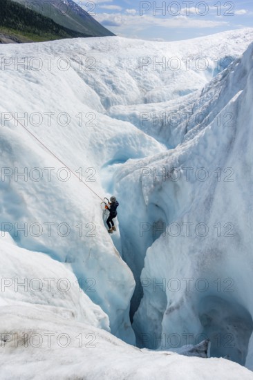 Ice climbers in an ice canyon, Root Glacier, Wrangell St. Elias National Park, Alaska, USA