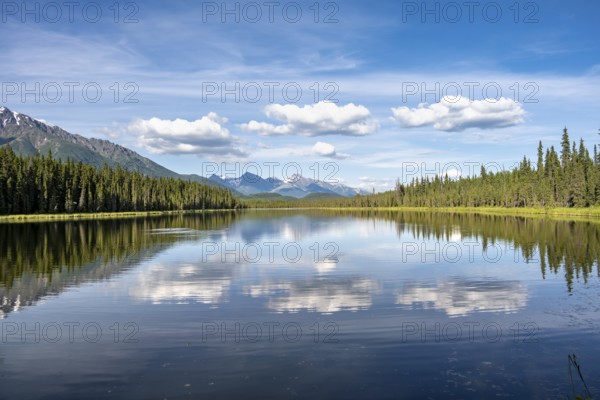 Mountains are reflected in idyllic Crystal Lake, McCarthy Highway, Wrangell St. Elias National Park, Alaska, USA