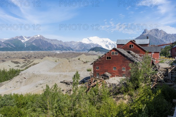 Red Kennicott buildings in front of mountainous landscape, Kennicott Concentration Mill to extract copper from quarried rock, Historic Kennecott Copper Mine, National Historic Landmark, Wrangell St. Elias National Park, Alaska, USA