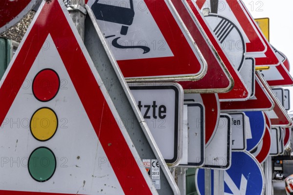 Storage for traffic signs in the yard of a road maintenance department, various signs with commandments and prohibitions, information about dangers, road traffic
