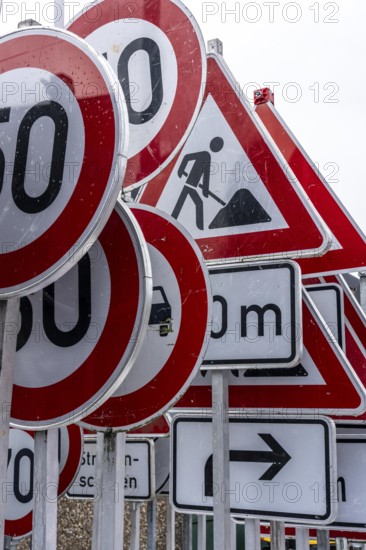 Storage for traffic signs in the yard of a road maintenance department, various signs with commandments and prohibitions, information about dangers, road traffic