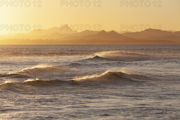Evening light at Cape Byron with view to Mount Warning and sunlit hinterland, New South Wales, Australia