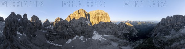 Aerial view, alpine panorama, Cima Tosa and rocky peaks at sunrise with alpine glow, picturesque mountain landscape, Brenta Dolomites, Trentino, Italy