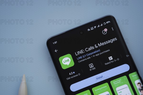 Dhaka, Bangladesh- 29 May 2025: On a blue surface, a smartphone displays the LINE app within the Google Play Store