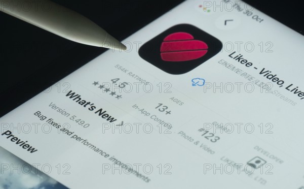 Dhaka, Bangladesh- 30 Oct 2025: Likee app on a iPad screen with a pen pointing at the install option