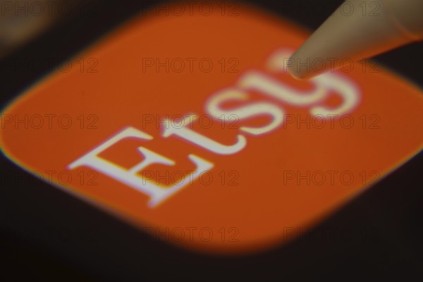 Dhaka, Bangladesh- 06 Dec 2025: Close-up of the Etsy app on a screen with a stylus pointing at it