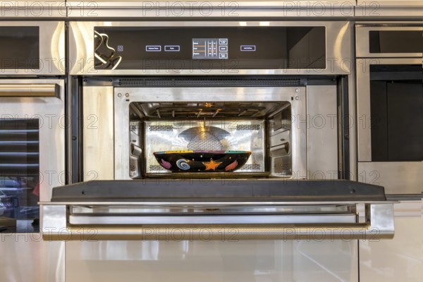 Modern kitchenware and microwave in luxury designer kitchen. Food preparation with expensive kitchen tools