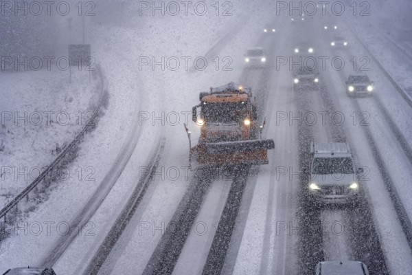 The onset of winter in North Rhine-Westphalia, heavy snowfall, A3 motorway near Hilden, near Ohligser Heide rest area, snow-covered roads, winter service of the motorway maintenance department with stray and clearing vehicles, traffic is sometimes only stalled, North Rhine-Westphalia, Germany