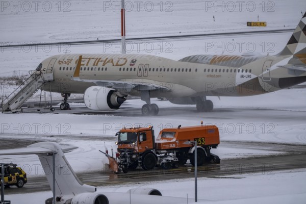 The onset of winter in North Rhine-Westphalia, flight operations are maintained at Düsseldorf airport with great effort, taxiways, runway are freed from snow and ice with many clearing vehicles, airplanes are de-iced in front of takeoff, North Rhine-Westphalia, Germany