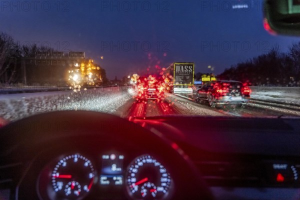 Driving in winter, in snow, motorway, rear lights, brake lights, speedometer, cockpit