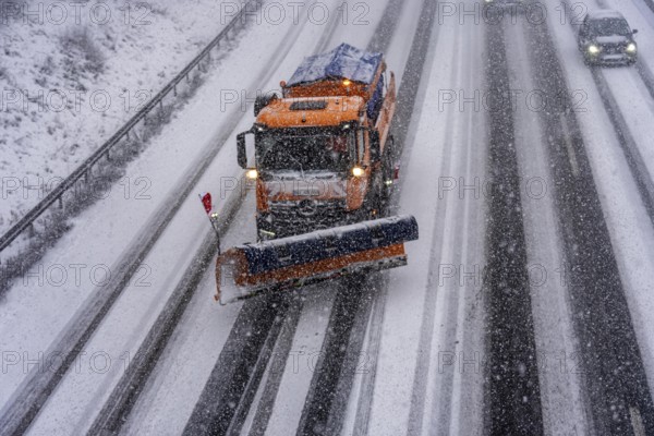 The onset of winter in North Rhine-Westphalia, heavy snowfall, A3 motorway near Hilden, near Ohligser Heide rest area, snow-covered roads, winter service at the motorway maintenance department with clearing vehicles, traffic is sometimes just stalling, North Rhine-Westphalia, Germany