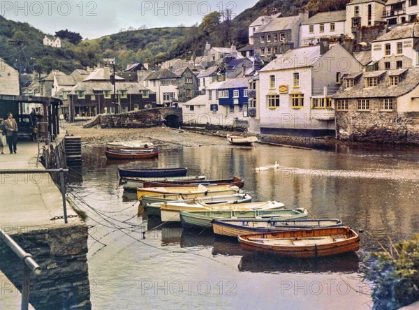 Historic waterfront buildings around the harbour river mouth of the River Pol at village of Polperro, Cornwall, England, UK