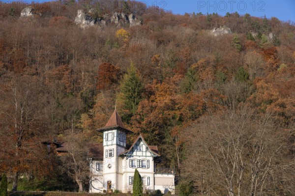 Historic villa in mixed autumn forest in Franconian Switzerland, Muggendorf, Upper Franconia, Bavaria, Germany