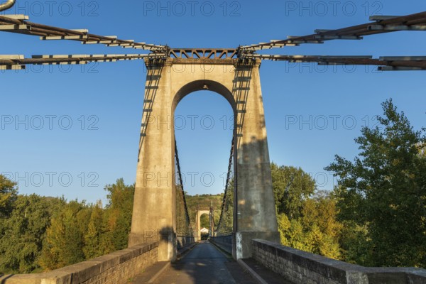 Suspension bridge of Coudes village on river Allier. Puy de Dome. Auvergne Rhone Alpes. France