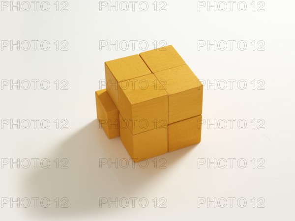 8 yellow wooden cubes against a white background