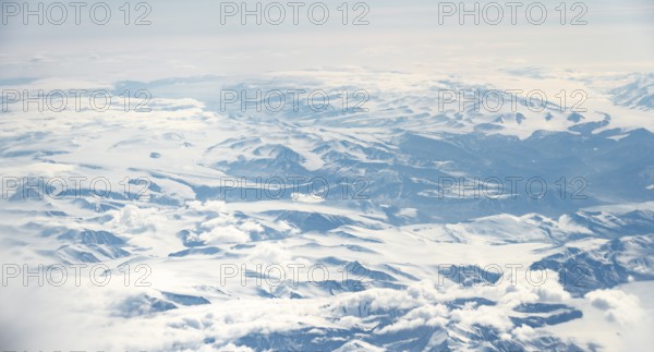 Icy, snowy arctic mountain landscape with glaciers, aerial view, Greenland, Arctic