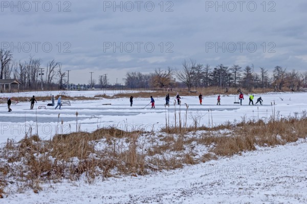 Detroit, Michigan USA - 1 January 2026 - As temperatures dropped and snow fell in the Great Lakes region, people shoveled ice off Lake Okonoka in Belle Isle State Park to play ice hockey on New Year's Day