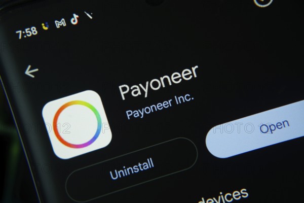 Dhaka, Bangladesh- 27 July 2025: Screen displaying Payoneer app with open and uninstall options, dark interface