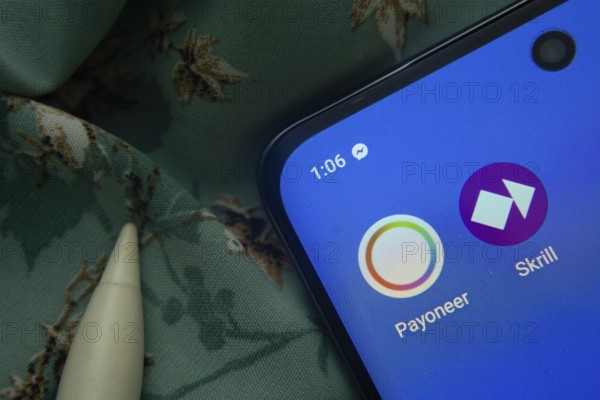 Dhaka, Bangladesh- 07 May 2025: Payoneer and Skrill app icon is seen on smartphone
