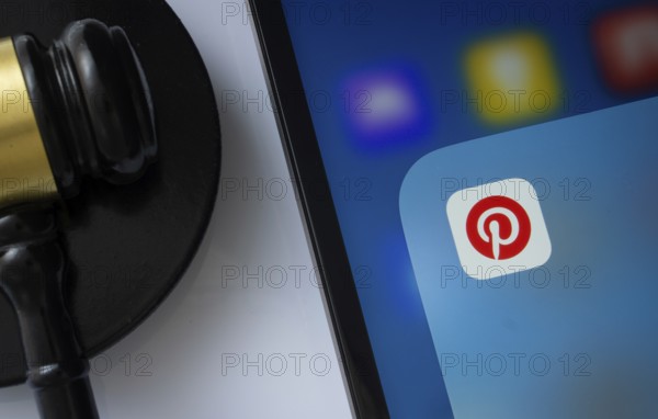 Dhaka, Bangladesh- 05 March 2025: A close up of an iPad screen displaying the Pinterest app alongside a judge's gavel