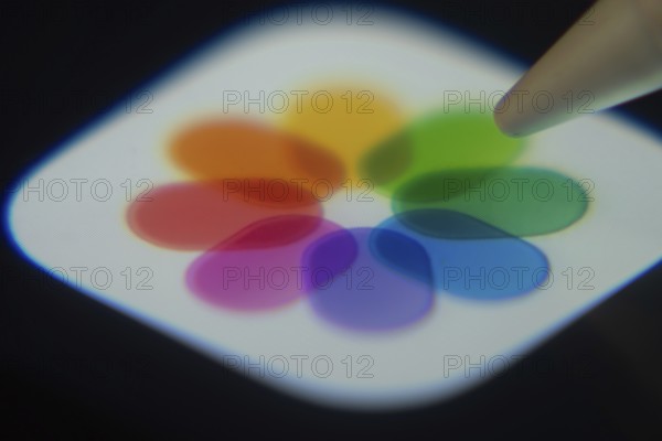Dhaka, Bangladesh- 06 Dec 2025: Close-up of the Apple Photos app on a screen with a stylus pointing at it