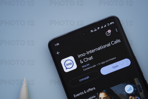 Dhaka, Bangladesh- 29 May 2025: On a blue surface, a smartphone displays the imo app within the Google Play Store