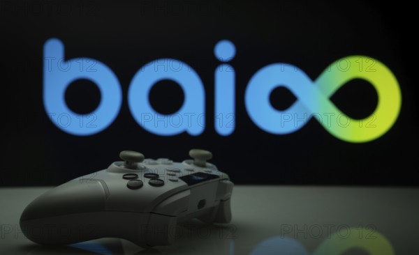Dhaka, Bangladesh- 20 Mar 2025: A close-up of a white gamepad with the Baioo Family Interactive Ltd seen on screen in the background