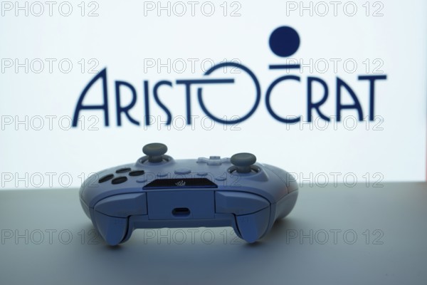 Dhaka, Bangladesh- 08 Apr 2025: A gaming controller in front of a Aristocrat screen