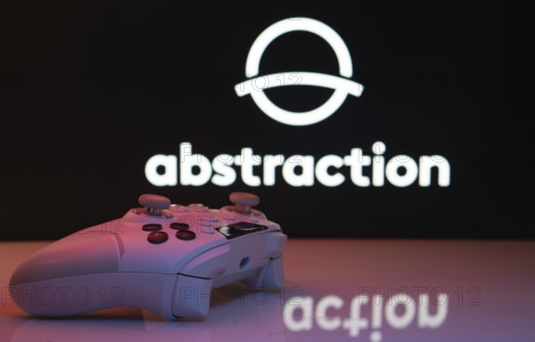 Dhaka, Bangladesh- 20 Mar 2025: A close-up of a white gamepad with the Abstraction seen on screen in the background