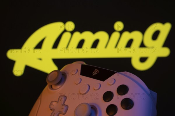 Dhaka, Bangladesh- 20 Mar 2025: A close-up of a gamepad with the Aiming Inc seen on screen in the background