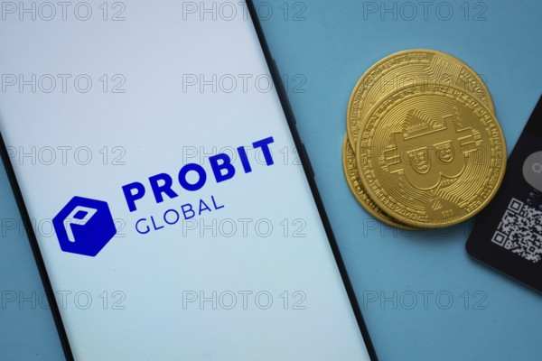 Dhaka, Bangladesh- 26 Aug 2025: Smartphone displaying ProBit Global logo surrounded by Bitcoin coins and payment cards