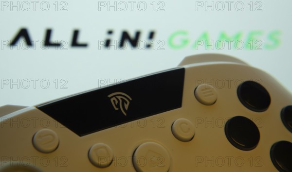 Dhaka, Bangladesh- 24 Mar 2025: A close-up of a gamepad with All in! Games the seen on screen in the background