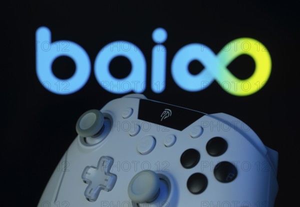 Dhaka, Bangladesh- 20 Mar 2025: A close-up of a gamepad with the Baioo Family Interactive Ltd seen on screen in the background