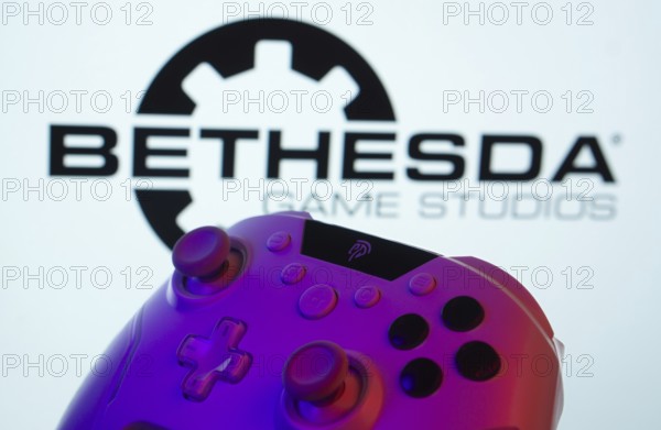 Dhaka, Bangladesh- 20 Mar 2025: A close-up of a gamepad with the Bethesda Game Studios seen on screen in the background
