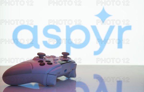 Dhaka, Bangladesh- 20 Mar 2025: A close-up of a white gamepad with the Aspyr seen on screen in the background