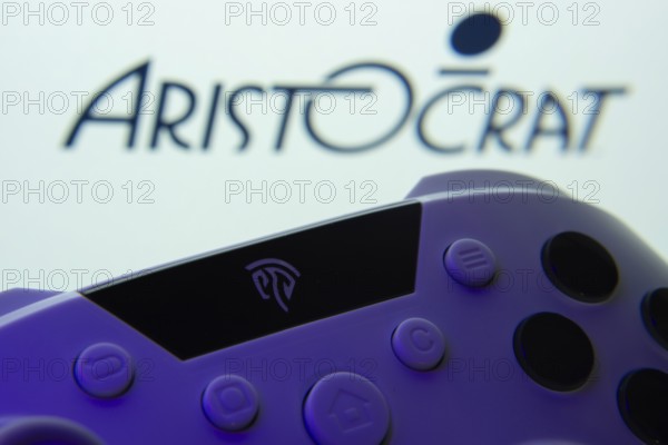 Dhaka, Bangladesh- 24 Mar 2025: A close-up of a gamepad with the Aristocrat seen on screen in the background