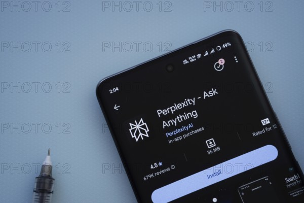 Dhaka, Bangladesh- 29 May 2025: On a blue surface, a smartphone displays the Perplexity app within the Google Play Store