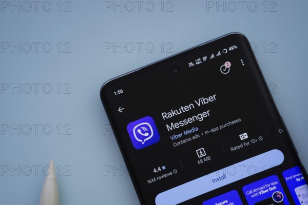 Dhaka, Bangladesh- 29 May 2025: On a blue surface, a smartphone displays the Rakuten Viber app within the Google Play Store