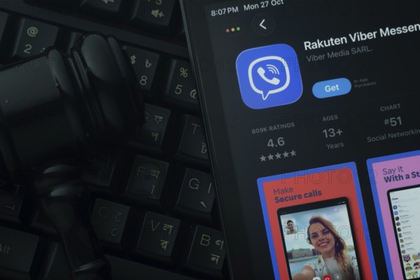 Dhaka, Bangladesh- 28 Oct 2025: An iPad displaying the Rakuten Viber app against a judge's gavel and dark keyboard background